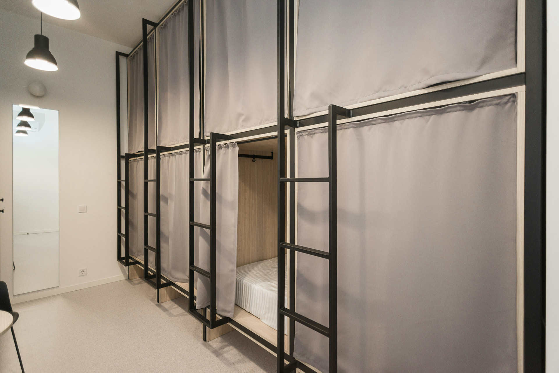 Hostel dormitory bunk pods with privacy curtains